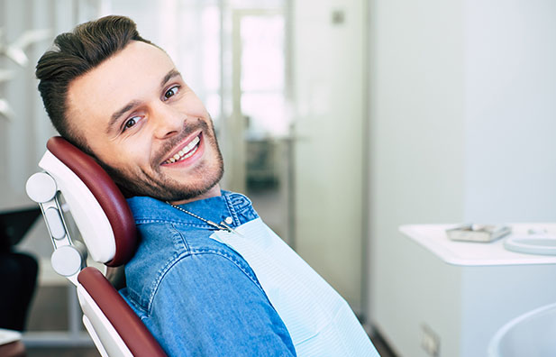 Young man sitting in dental chair